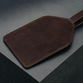 Adjustable leather strap secures the tee holder to your bag