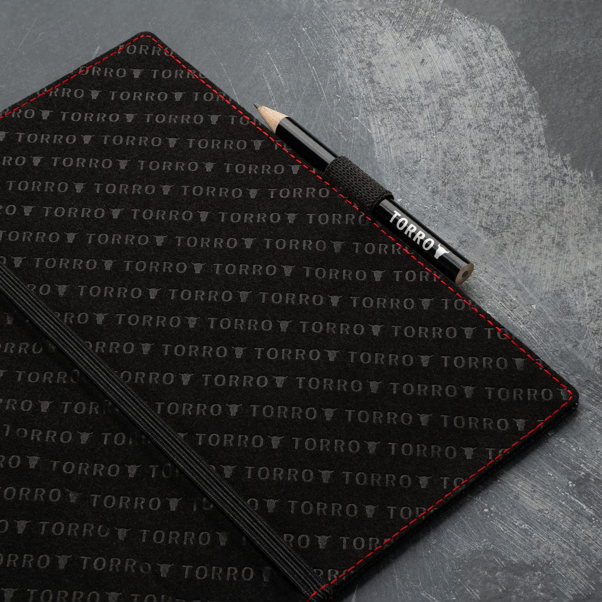 Elastic pencil holder with TORRO pencil for on-course notes.