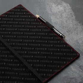 Elastic pencil holder with TORRO pencil for on-course notes.