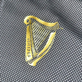 Traditional Craft Guinness harp polo fabric texture demonstrating durable moisture-wicking material.