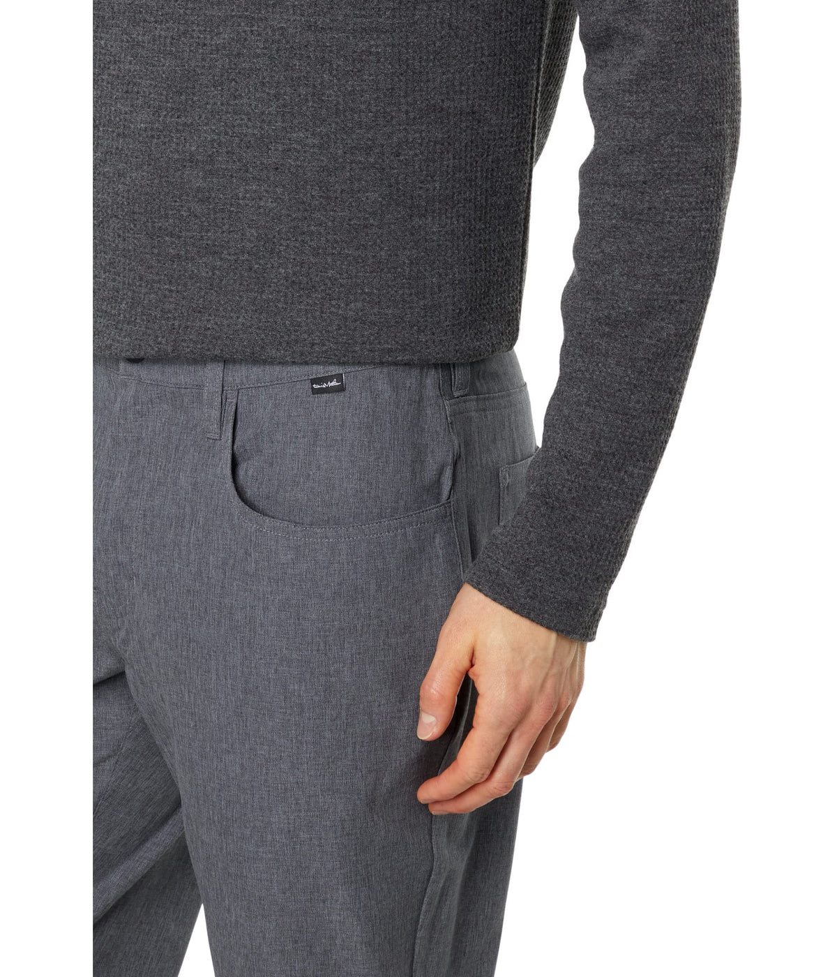 TravisMathew Open to Close pants worn in motion in Heather Dark Grey.