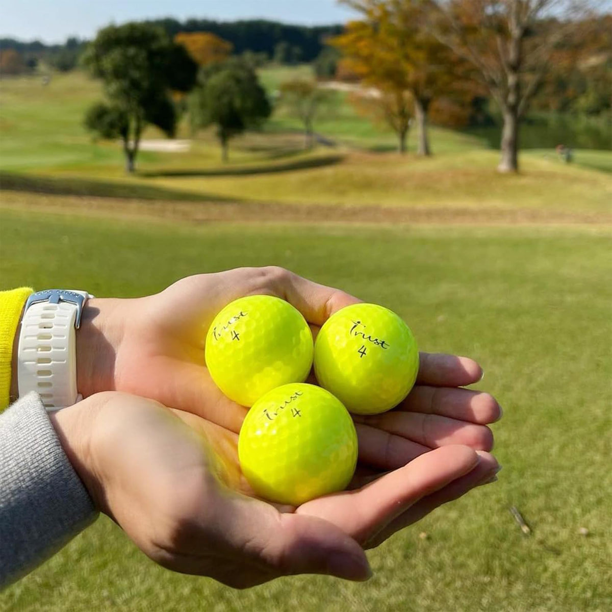 Trust Golf Ball packaging shows a 12-ball pack for value