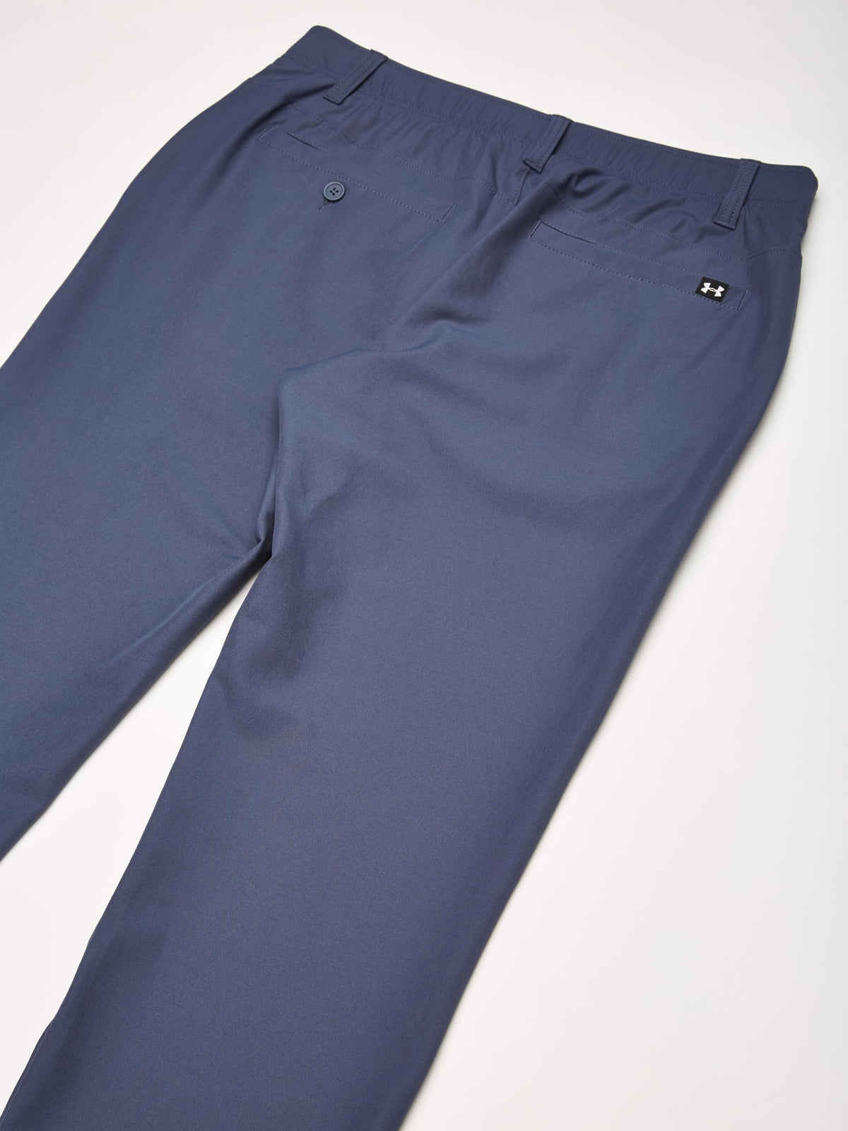 Under Armour Drive Pants flat-front design with four secure pockets.