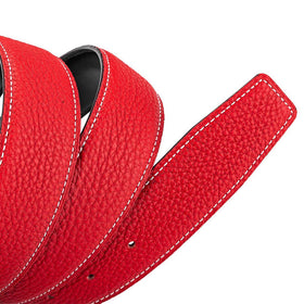 Close-up of Vatee's bright red strap surface, full-grain leather texture and gloss.