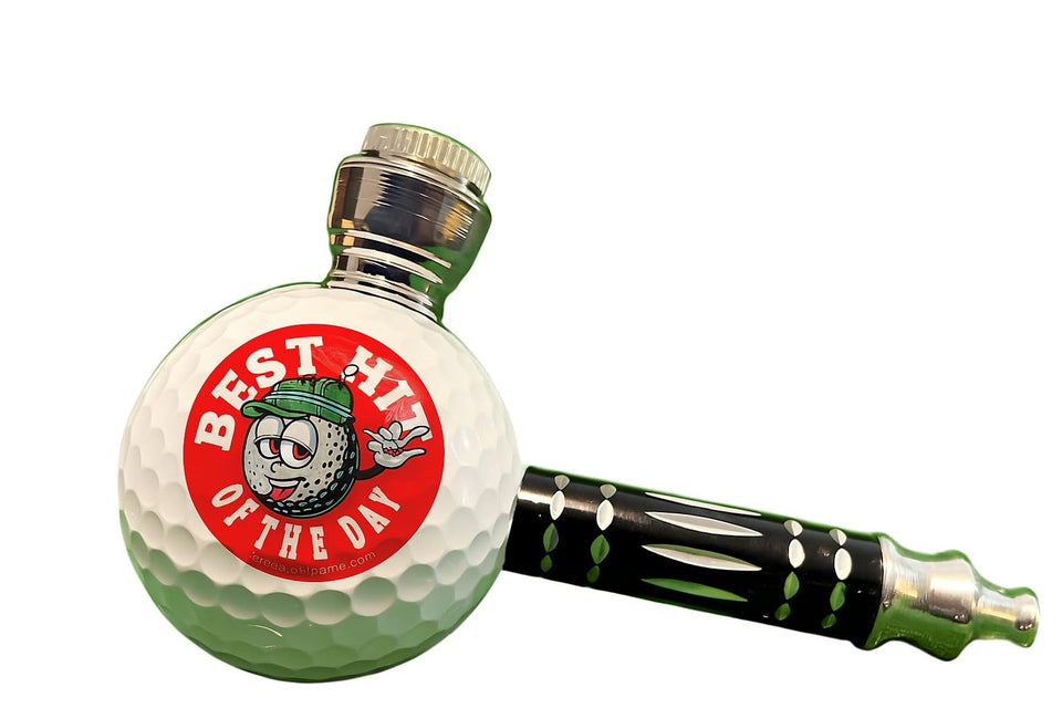 Vegas Golf Ball Pipe resting on a green, a portable novelty for golfers.