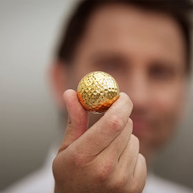 Vertini 24K Gold golf ball on display provides luxury accent for home or office.