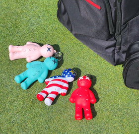 Close-up of turquoise Voodoo Golf tee holder showing compact bag attachment.