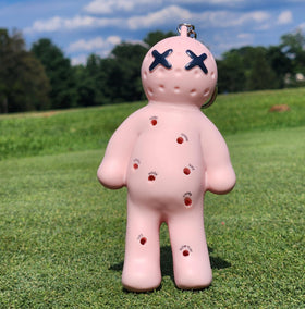 Voodoo Golf Ball Tee Holder close-up showing a secure tee clip in pink.
